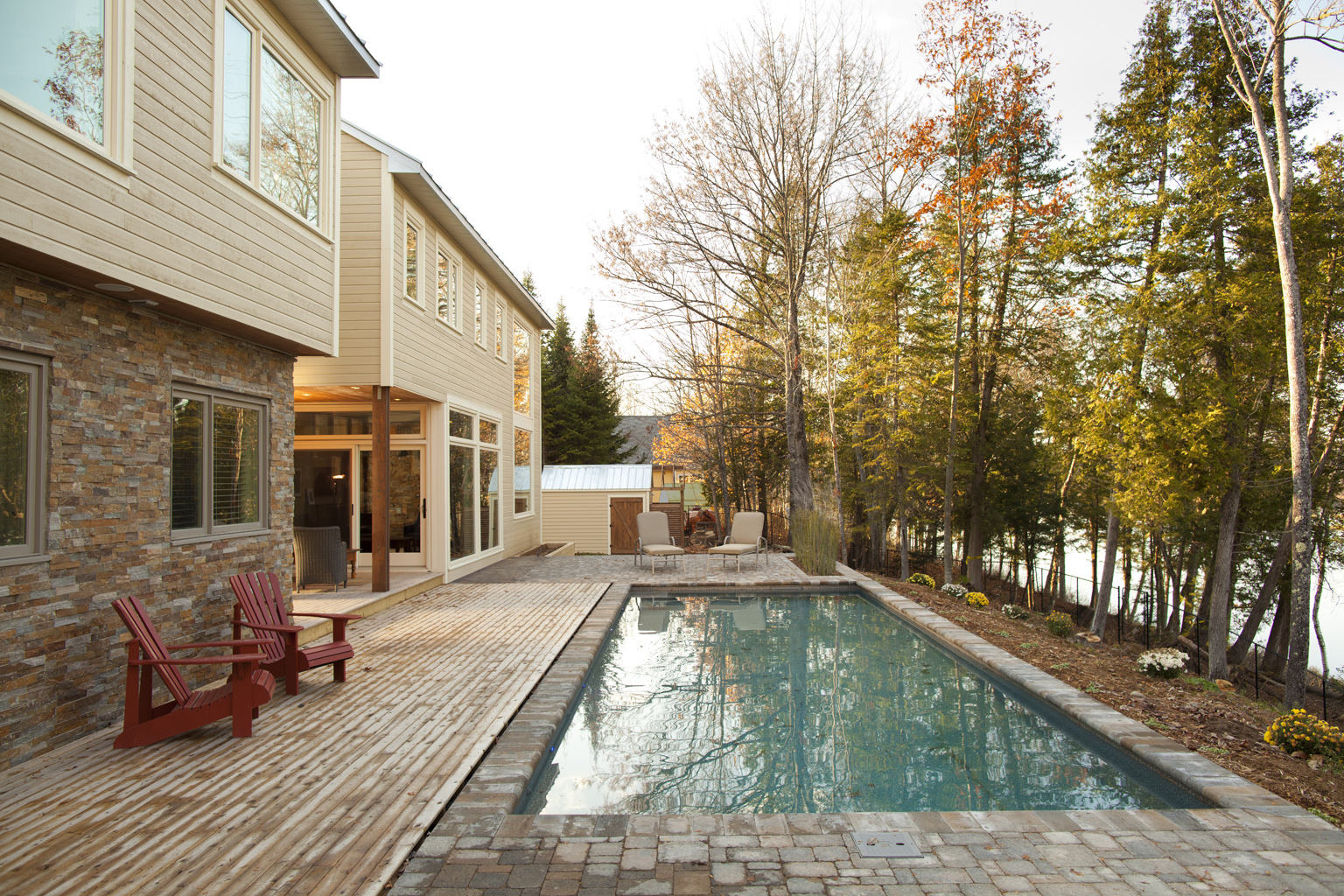 Home outdoor pool with bench in River Run showing house, garden and pool