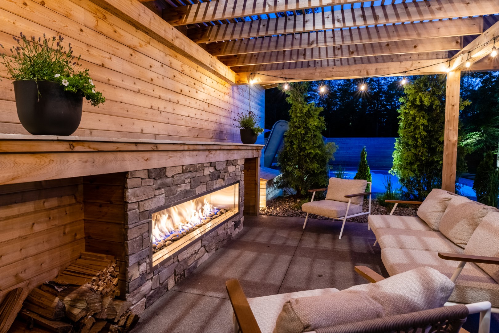 Roaring fireplace with seating in Pergola, installed in Moncton next to pool