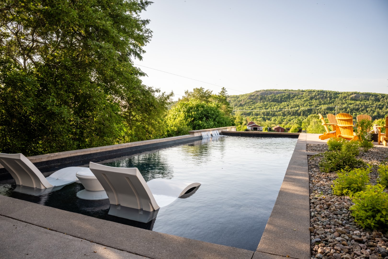 Pool with tanning ledge and water feature in Sussex