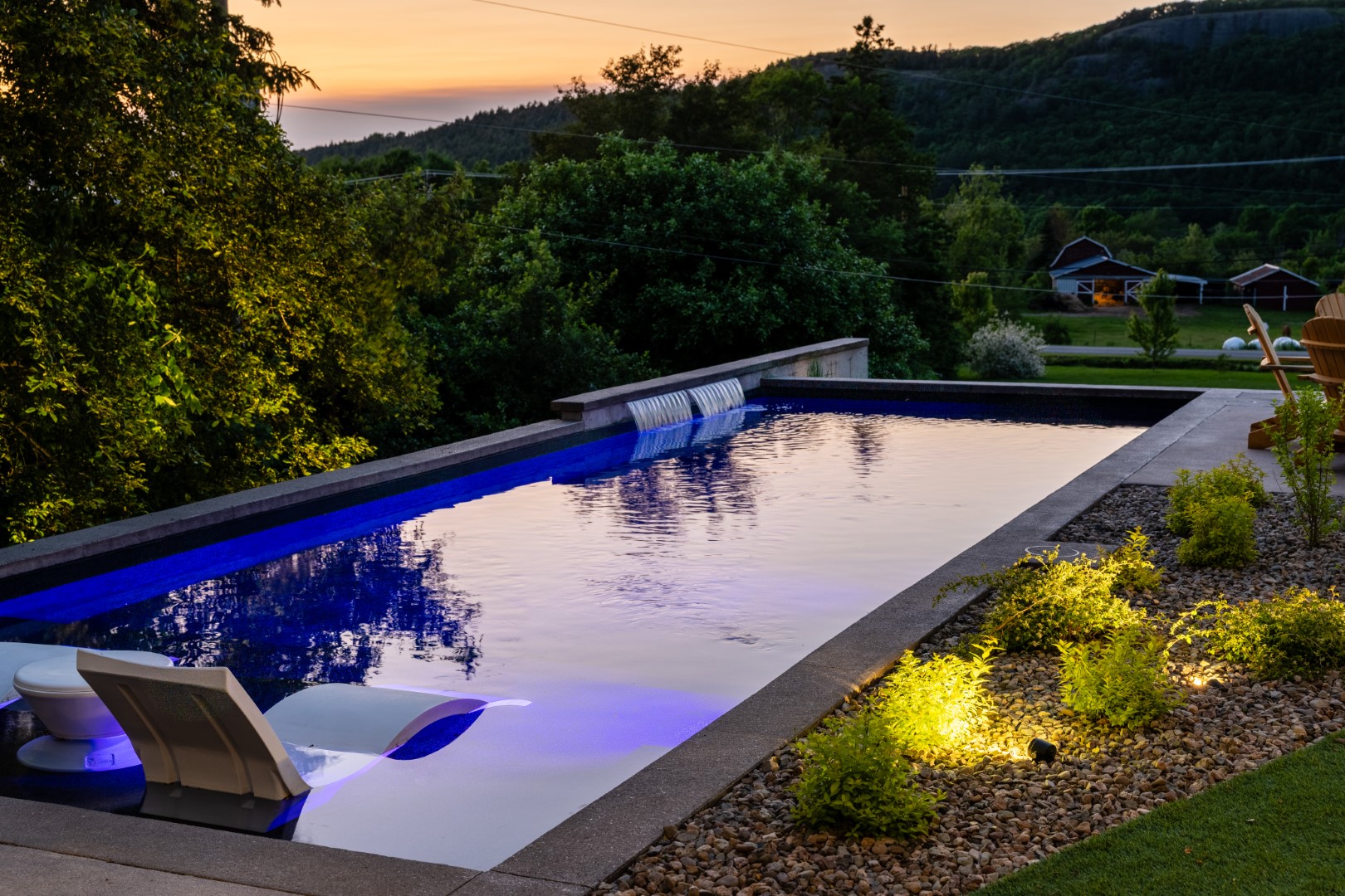 Home swimming pool with blue underwater lighting in a Sussex back garden