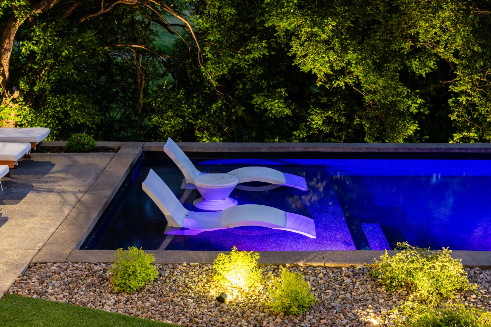 Tanning Ledge lit up with underwater lighting from swimming pool in Sussex home