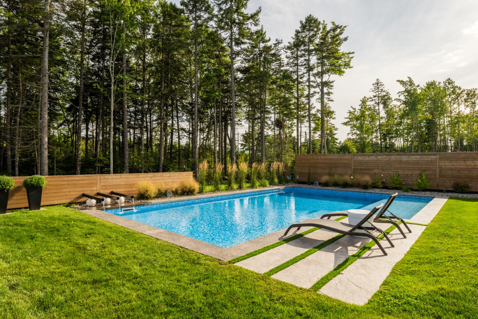 Back garden residential luxury swimming pool with water feature and sun loungers, Moncton NB