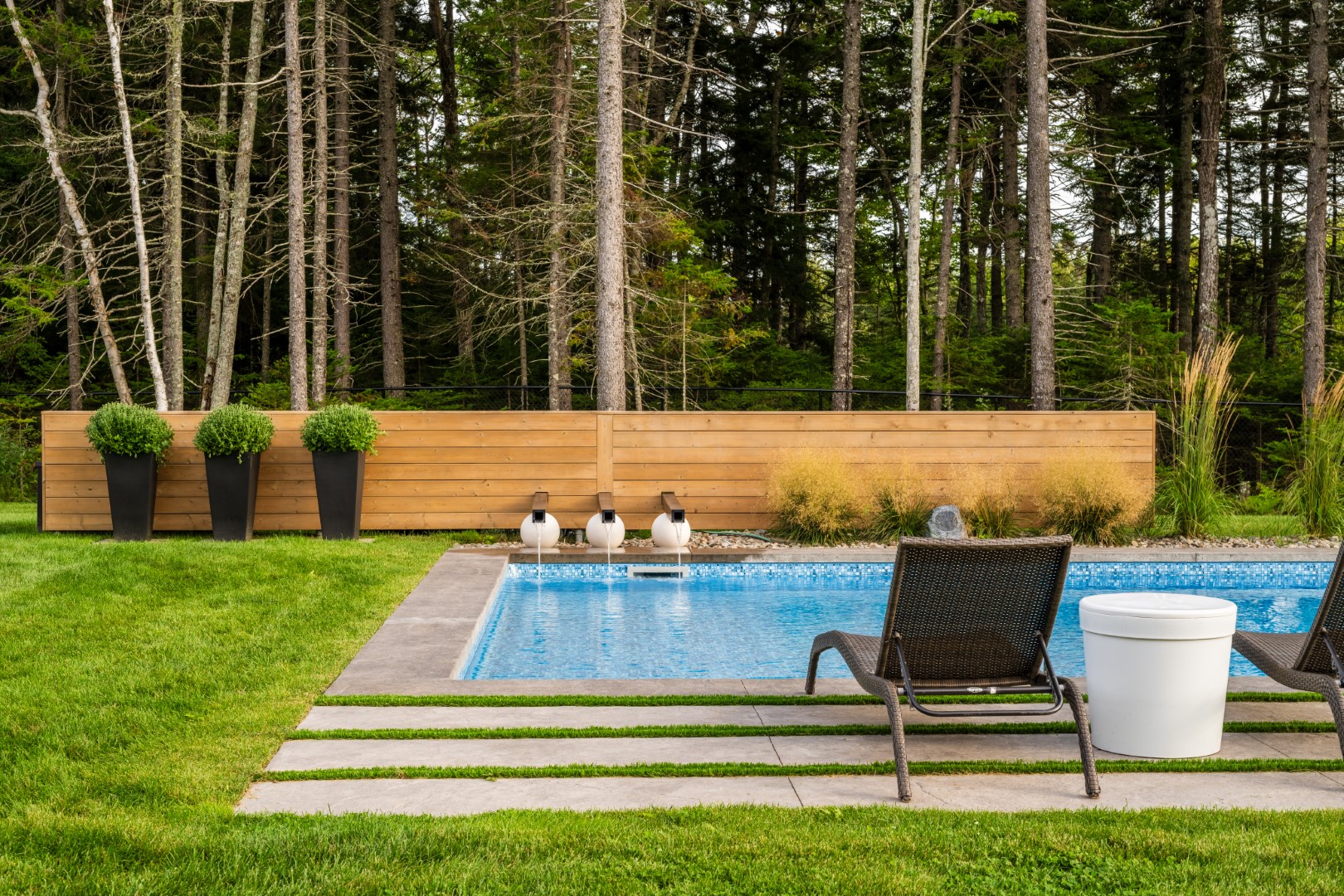 Large pool with tanning ledge and water feature in Moncton