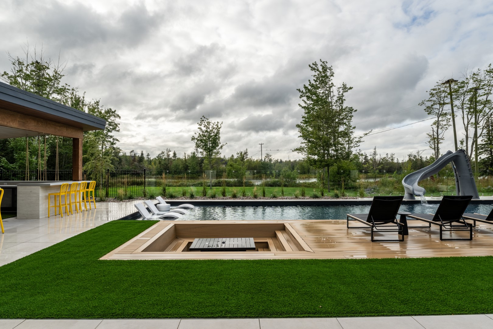 Sunken seating area alongside pool installation in Lakeview, Atlantic Canada