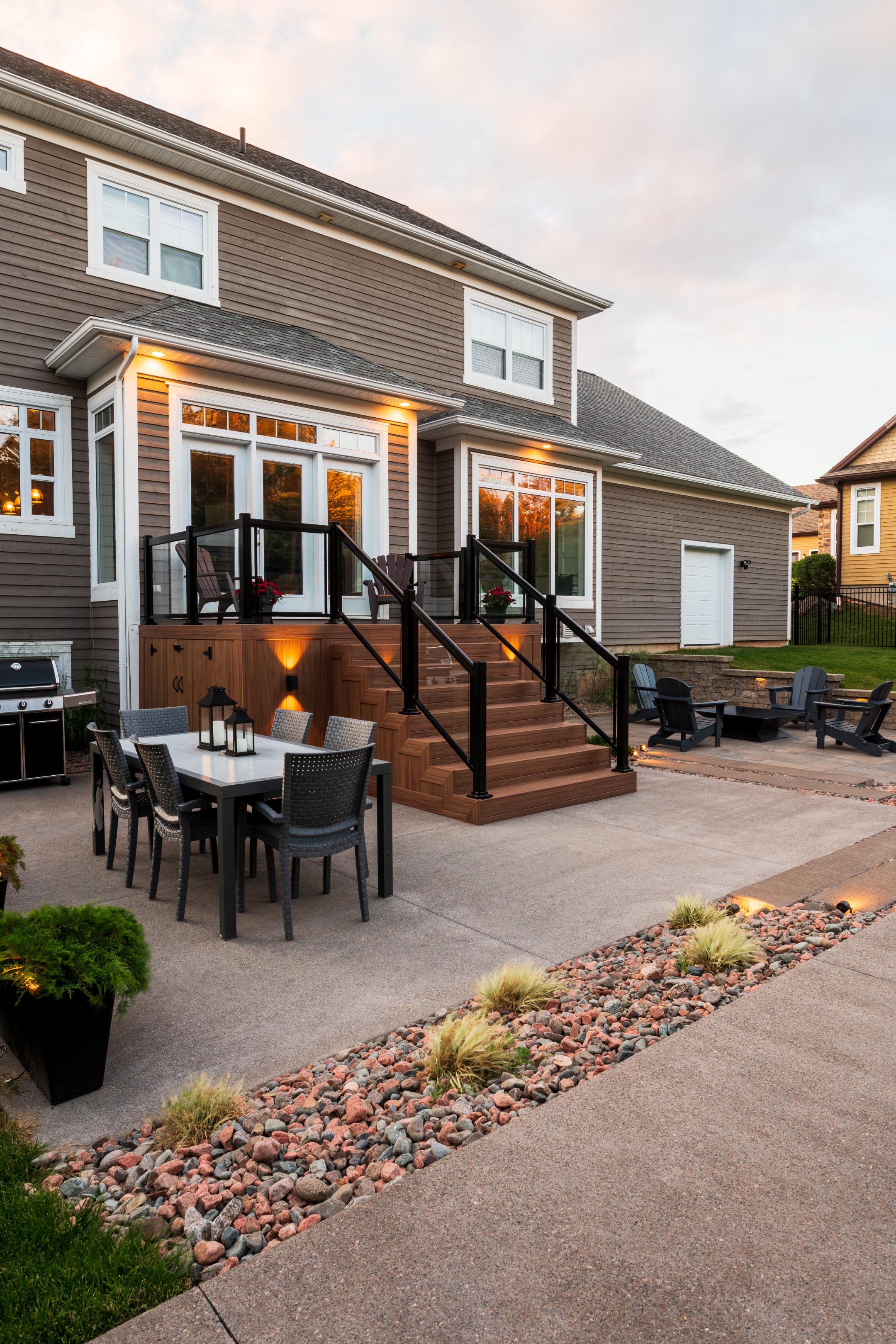 Stairs and decking with chairs and table in New Brunswick back garden