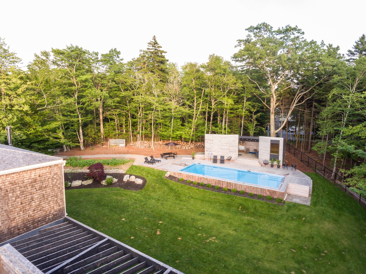 Overhead shot of luxurious home swimming pool with wooden diving board