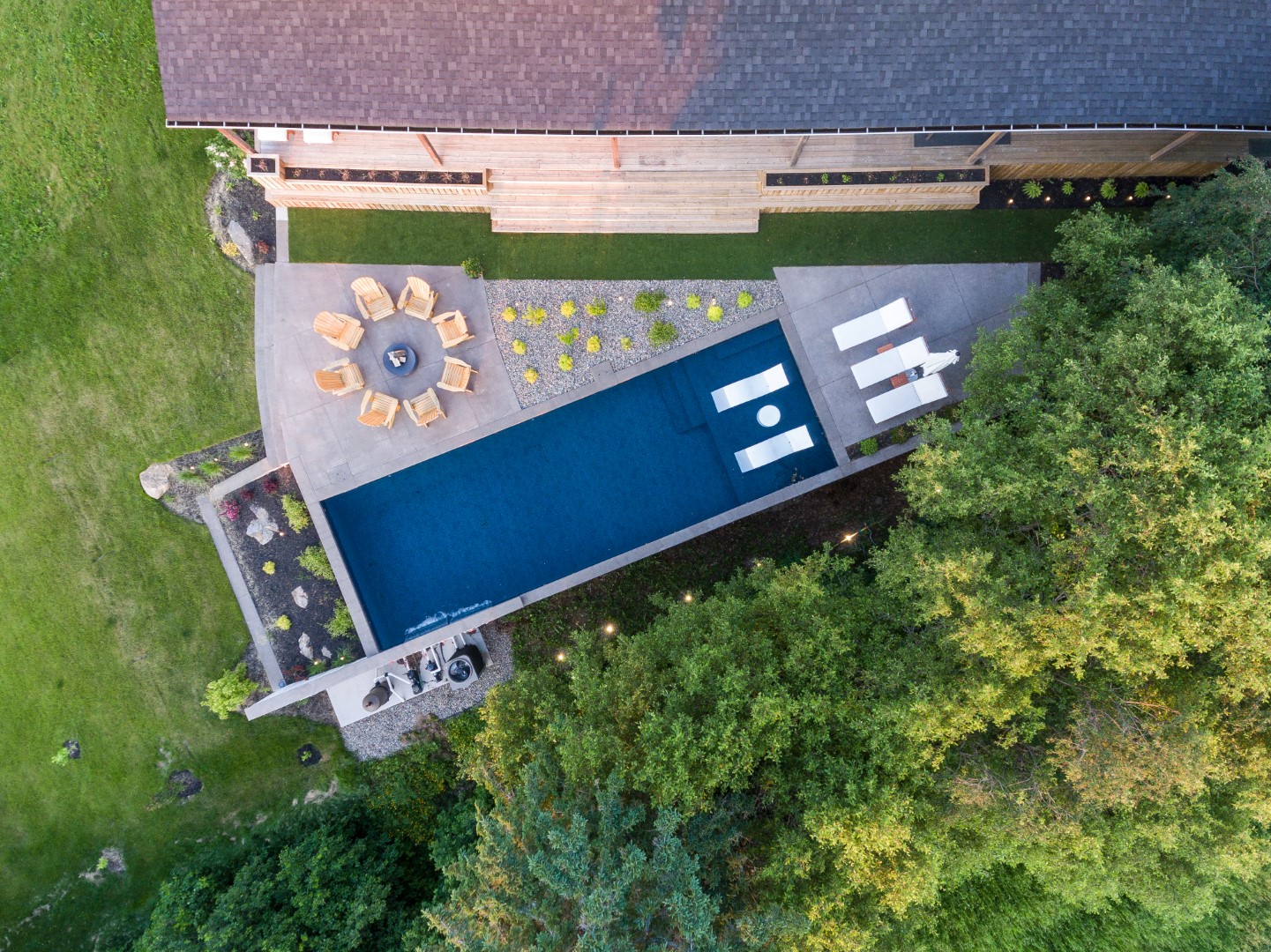 Drone shot of home swimming pool with tanning ledge in Sussex