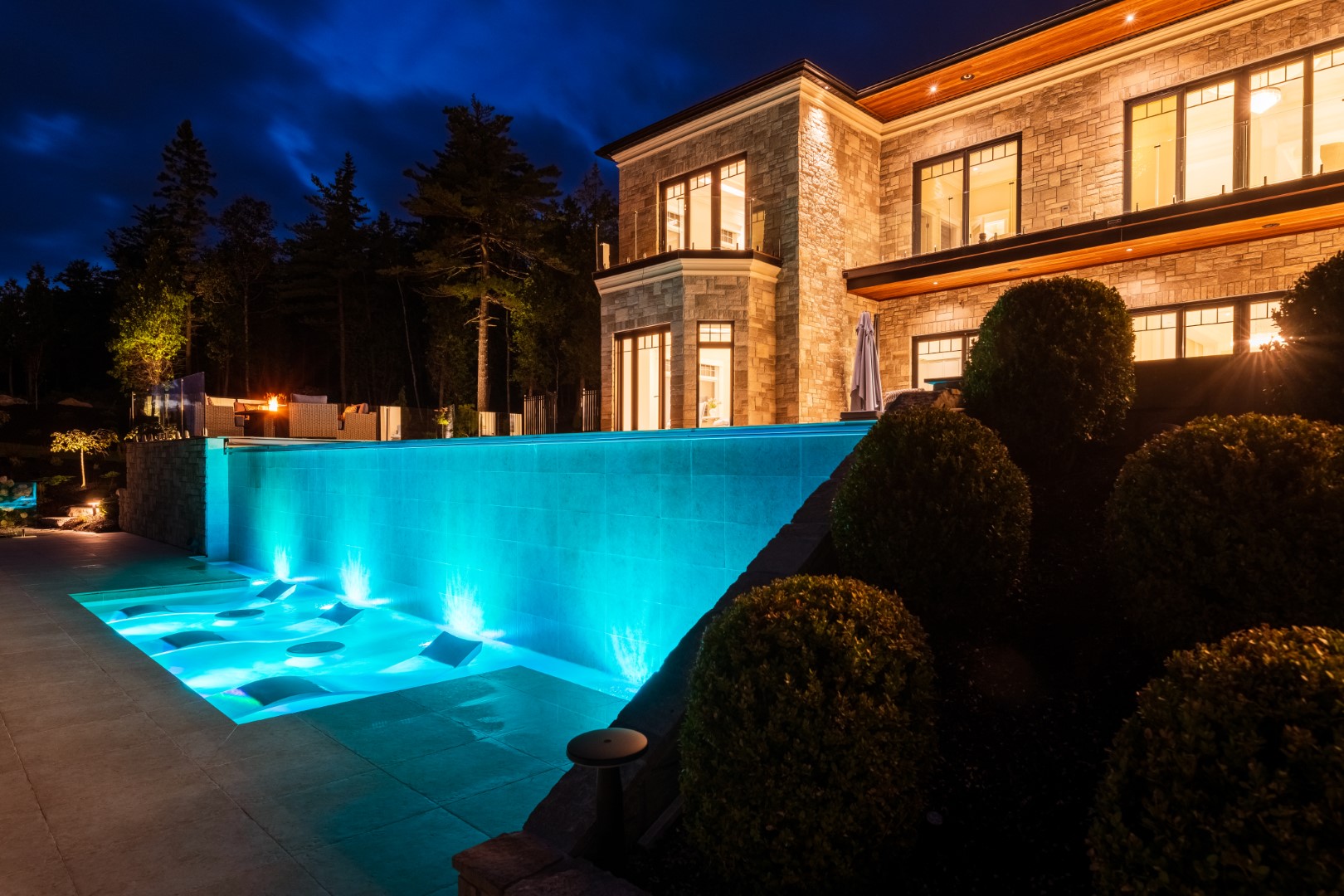 Lounge pool at base of concealed edge pool in Saint John back garden installation