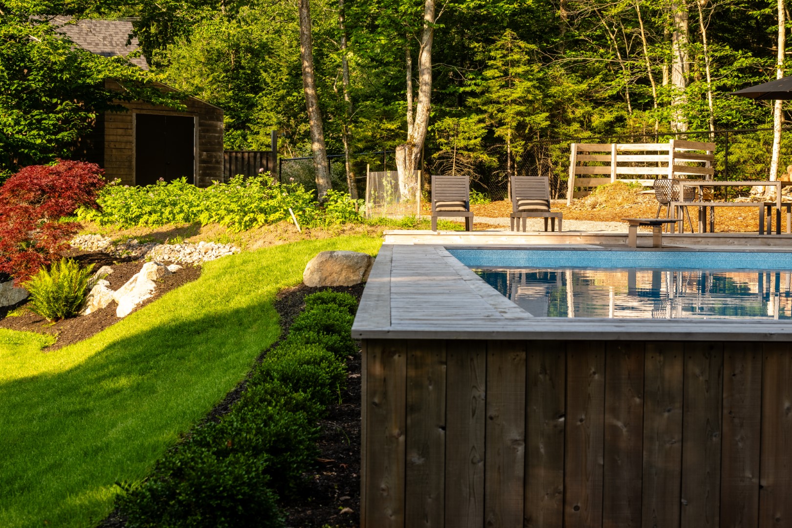 Wood skirting for home swimming pool with wooden diving board in Rothesay