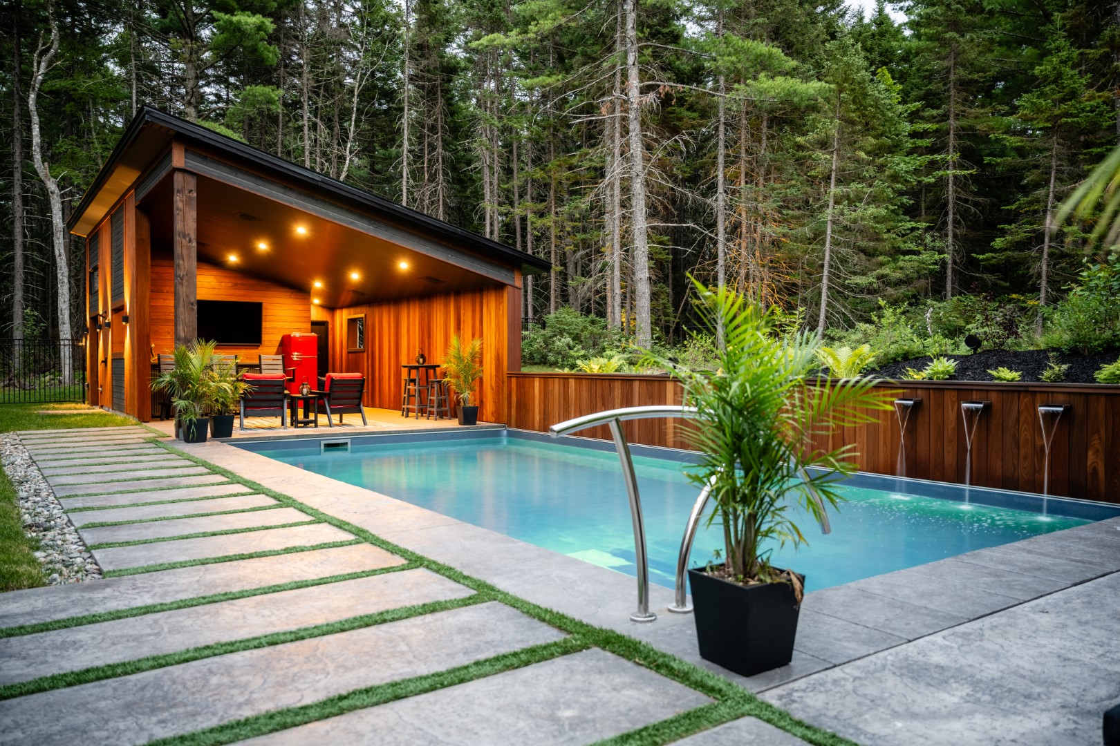 Pool and pool house with lighting both underwater and in the pool house in a home in Lakeburn