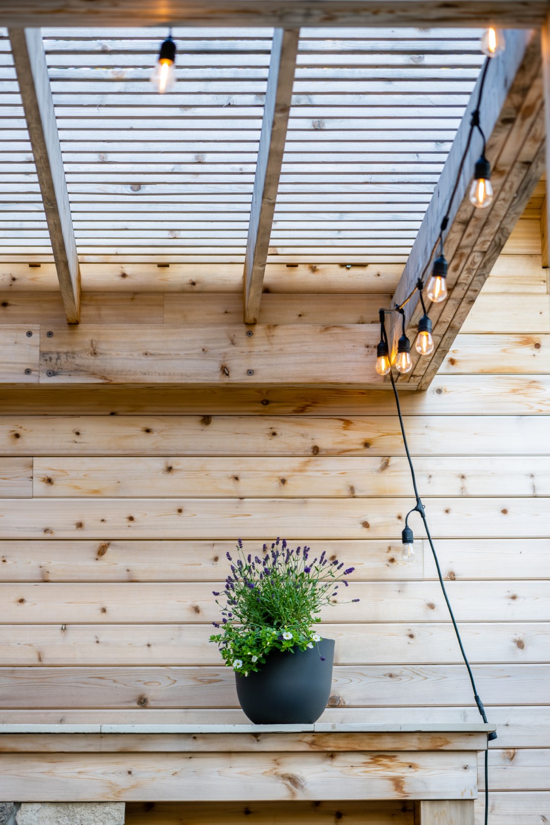 Pergola with fireplace, attached to pool house with storage and bathroom for pool installation in Moncton