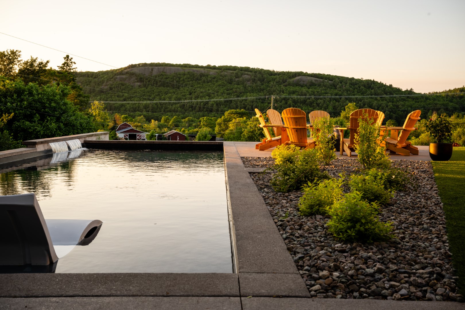 Pool with tanning ledge at dusk in Sussex