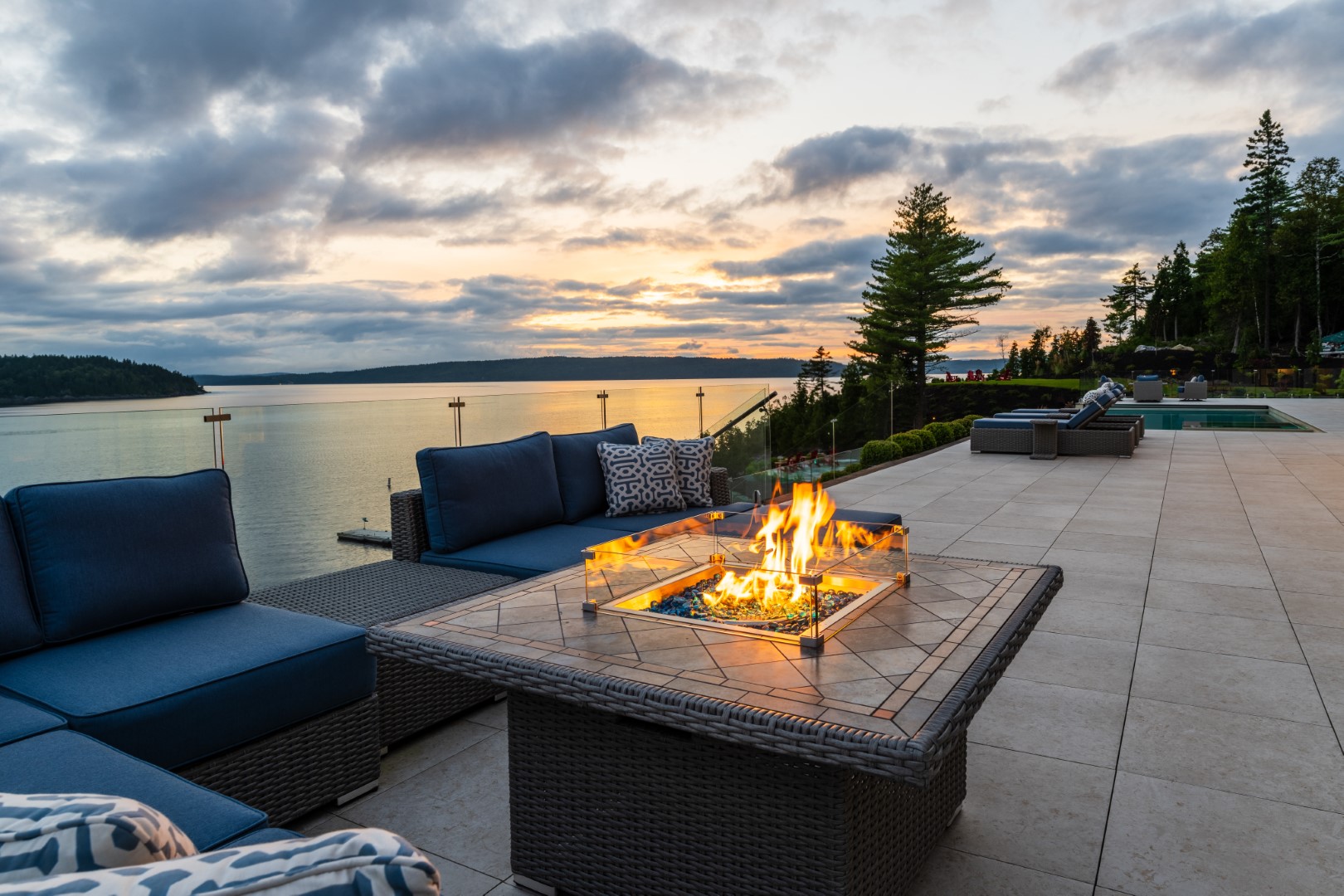 Fire pit patio in back garden next to luxury pool installation in St John