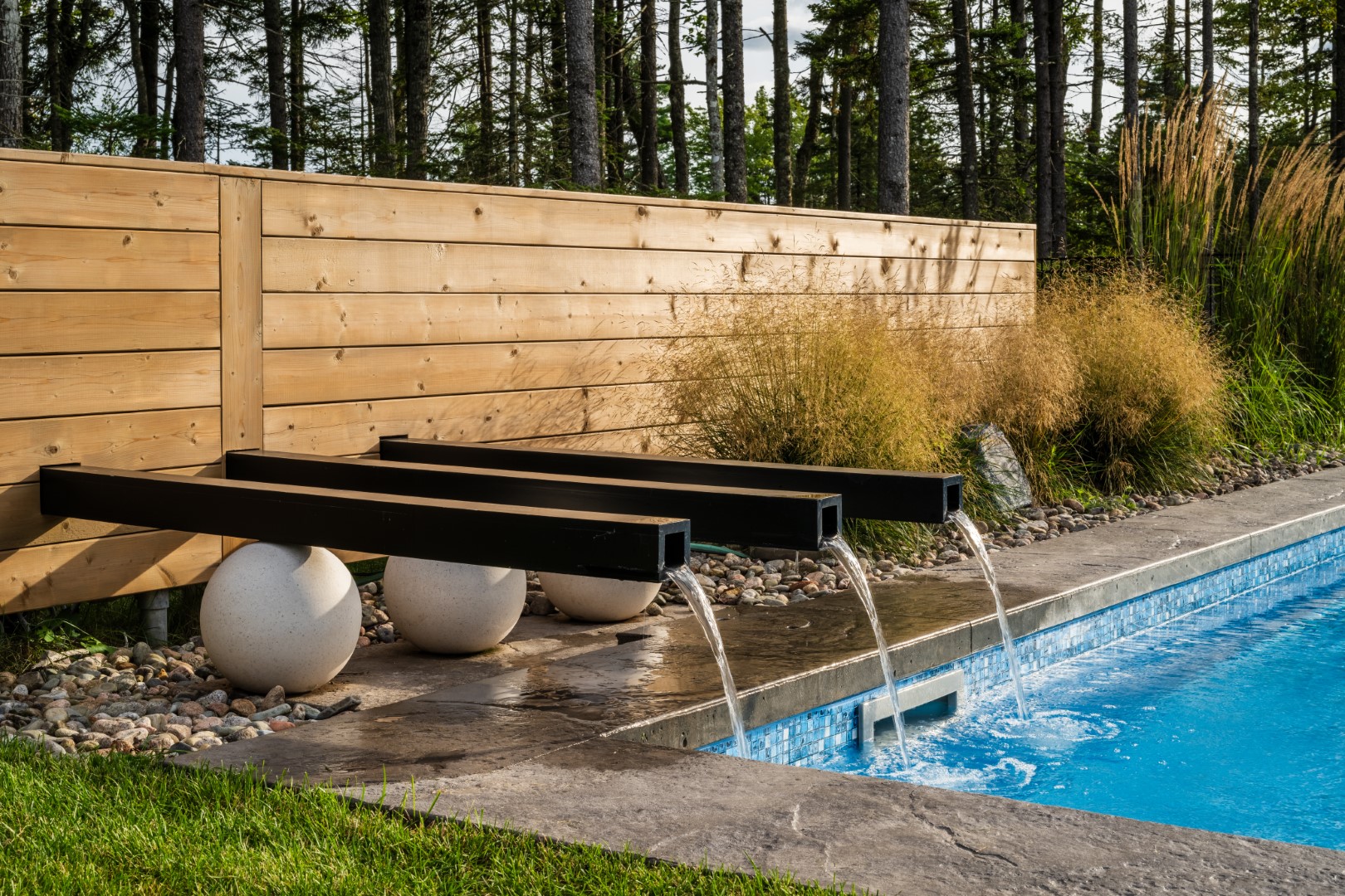 Water feature running into back garden home swimming pool in New Brunswick