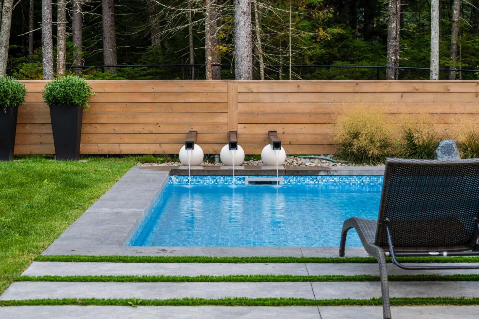 Back garden private swimming pool with water feature in New Brunswick