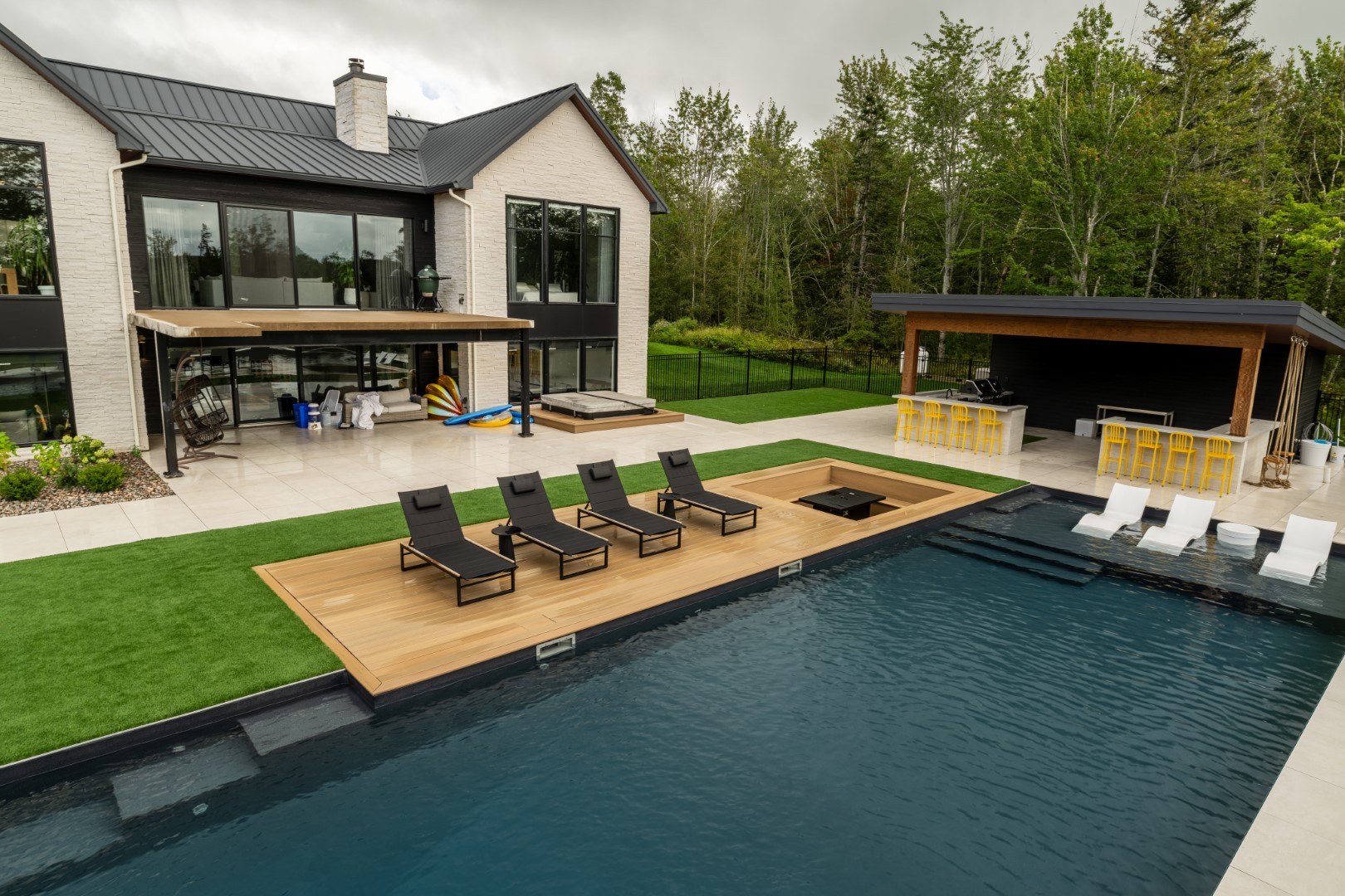 Overhead shot of luxury residential swimming pool with below ground concealed seating in Lakeview