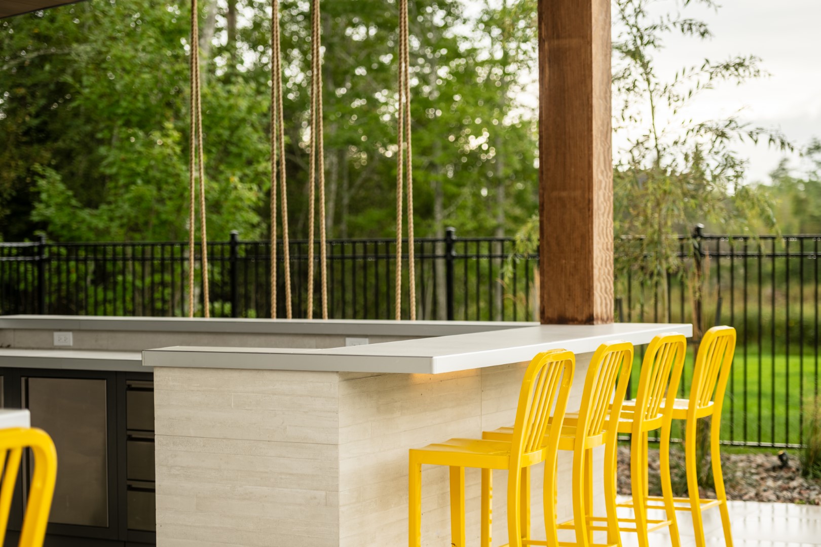 Under cover bar area as part of pool house in Lakeview by side of home swimming pool installation